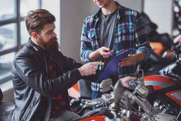 Fototapeta na wymiar Men in motorbike salon