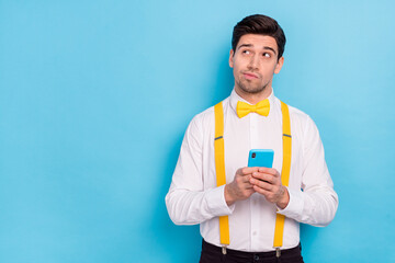 Portrait of serious minded man look interested empty space brainstorming isolated on blue color background