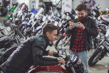 Obraz na płótnie Canvas Men in motorbike salon