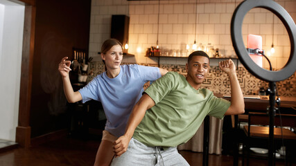 Dancing blogger couple make video on mobile phone