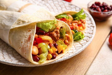 Plate with delicious burritos on light background, closeup