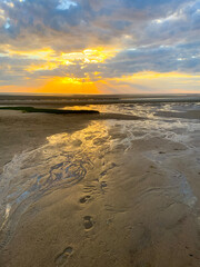 Sun Rays at Dusk over Cape Cod Bay Sand Flats with Footsteps
