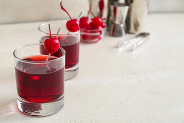 Glasses of tasty Manhattan cocktail on light background, closeup