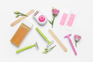 Different supplies for hair removal on white background