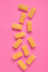Set of hair curlers on pink background