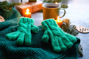 Warm gloves and sweater on table