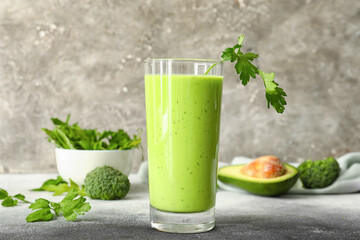 Glass of healthy green juice on table