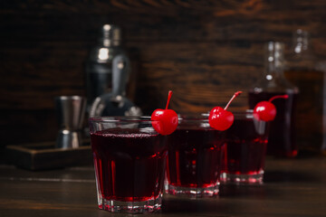 Glasses of tasty Manhattan cocktail on dark wooden background