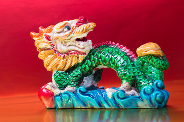 The symbol of the Chinese horoscope, the dragon statue on red background