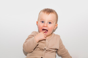 Boy points a finger in his mouth