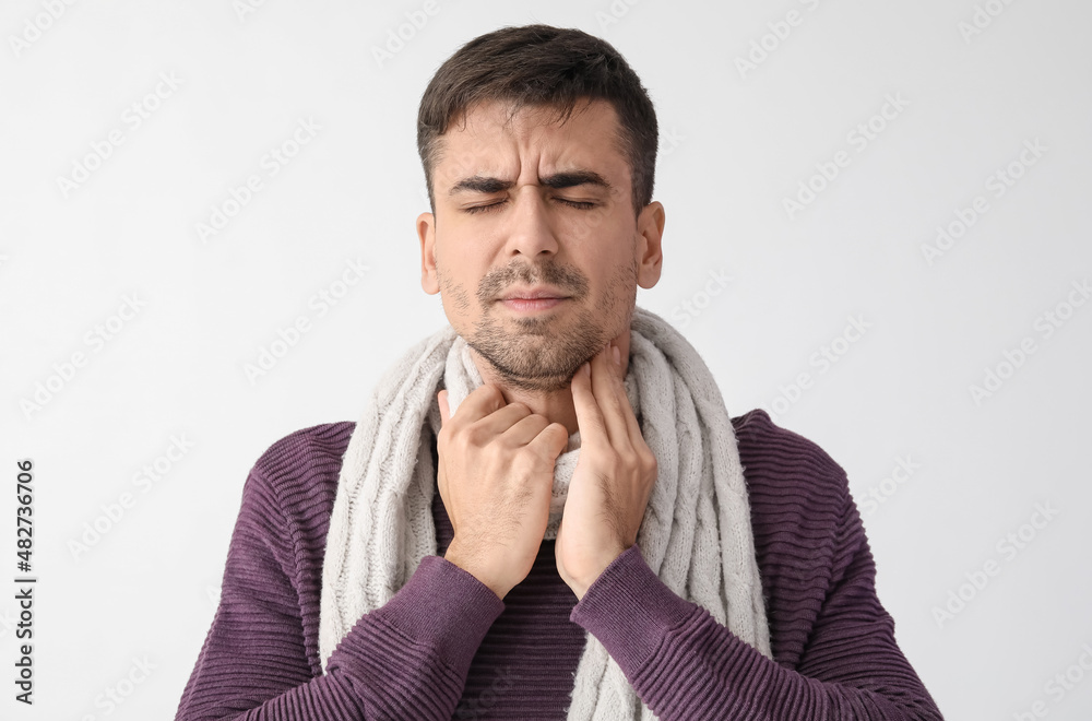 Canvas Prints Ill young man with sore throat on white background