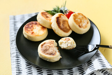 Plate with tasty cottage cheese pancakes on color background, closeup