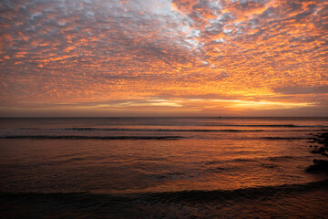 Fototapeta na wymiar Beautiful sunset with reflections on the water. Brazilian beach located in Jericoacoara, Ceara.