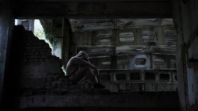 Social problems in people. A sad man in an abandoned building, a depressed man in a cinematic tone. Problems in the life of a young man, lost his job