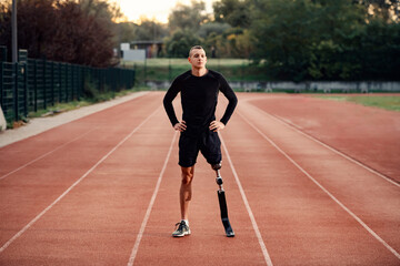 A sportsman with artificial leg preparing to workout at stadium.