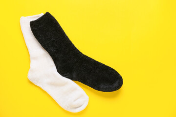 Pair of socks on yellow background