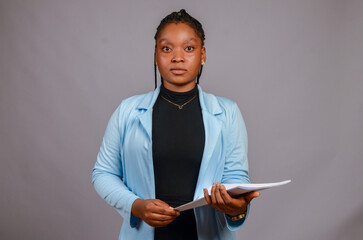 close up of a beautiful african lady in focused holding file