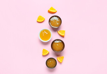 Composition with tasty orange jam on pink background