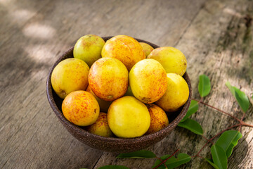Mangaba fruit from the northeast of Brazil on an aged wooden table.