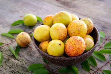 Mangaba fruit from the northeast of Brazil on an aged wooden table.