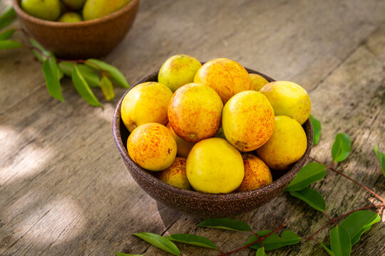 Mangaba fruit from the northeast of Brazil on an aged wooden table.
