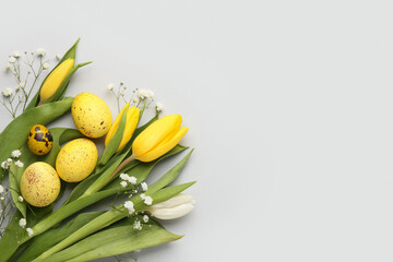 Composition with beautiful Easter eggs and flowers on white background