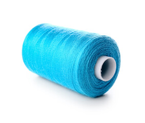 Blue sewing thread spool on white background