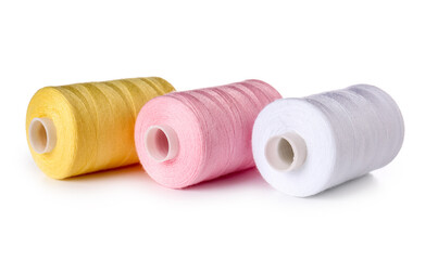 Different sewing thread spools on white background