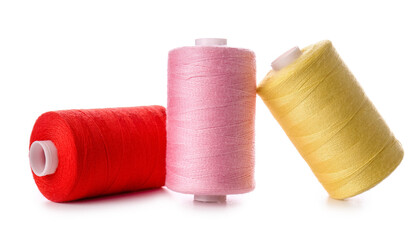 Different sewing thread spools on white background