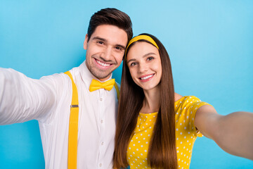 Fototapeta premium Photo of two positive friendly partners make selfie toothy smile isolated on blue color background