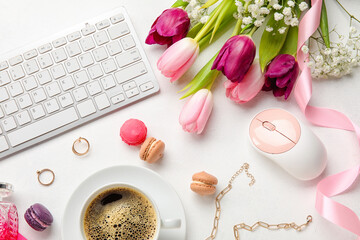 Composition with keyboard, computer mouse, cup of coffee, female accessories and beautiful flowers on light background, closeup
