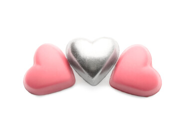 Tasty chocolate candies in shape of hearts on white background