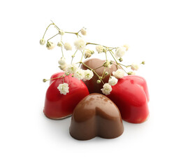 Composition with tasty chocolate candies and gypsophila flowers on white background