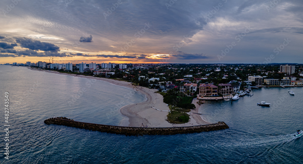 Wall mural aerial drone of sunset over city with beach and ocean. clouds in sky with empty space. pompano beach