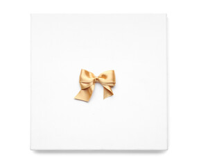 Board with golden ribbon bow on white background
