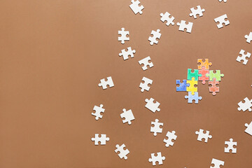 Different puzzle pieces on color background. Concept of autistic disorder