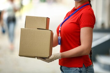 Female courier with parcels outdoors