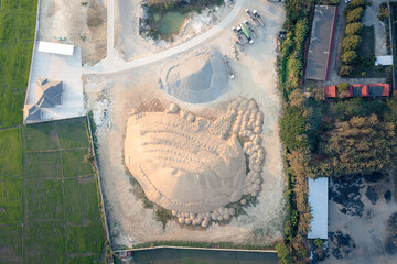 Pile of sand and rock or gravel in concrete plant in aerial view or top view. Heap of aggregate or material from nature, mine or quarry for mix with cement, concrete for industry construction work.