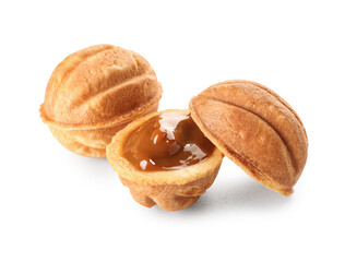 Tasty walnut shaped cookies with boiled condensed milk on white background