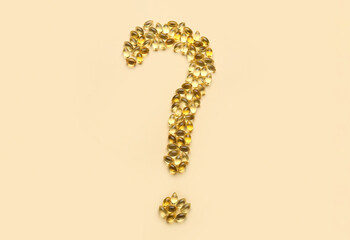 Question mark made of fish oil pills on color background