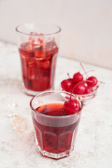 Glass of tasty Manhattan cocktail on light background