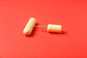Wine cork and opener on red background