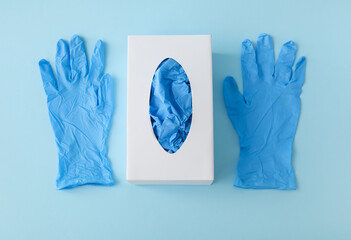 Paper box with medical gloves on blue background