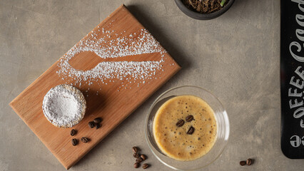 Coffee cup and small cake on table