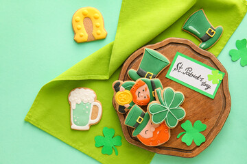Composition with tasty gingerbread cookies for St. Patrick's Day celebration on color background