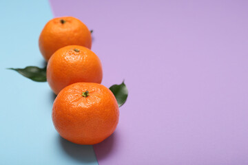 Ripe tangerines on color background