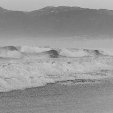 Waves With Mountain In Backround