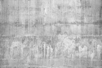 Real grey concrete wall with rough cracked grunge textures