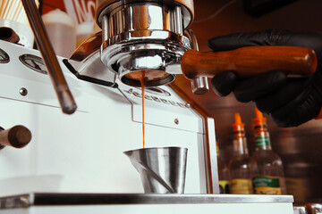 Fresh morning coffee pouring from a vintage coffeeshop espresso machine