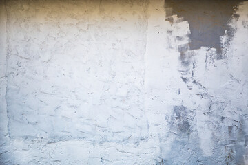 A real aged grey concrete wall texture with grungy white paint.